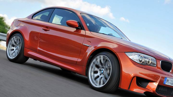 Side Pose Of 2011 BMW 1 Series M Runing in Orange
